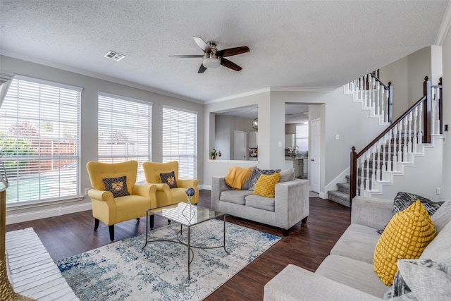 living room with a textured ceiling, ceiling fan, crown molding, and dark hardwood / wood-style flooring