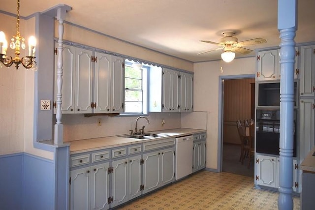 kitchen featuring a sink, light countertops, dishwasher, black oven, and ceiling fan with notable chandelier