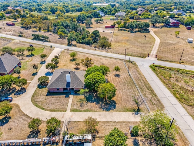 birds eye view of property with a rural view