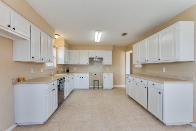 kitchen with dishwasher, white cabinets, and sink