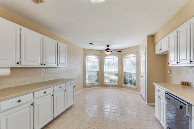 kitchen with white cabinets, a textured ceiling, ceiling fan, and dishwasher