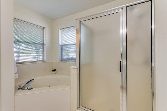 bathroom with shower with separate bathtub