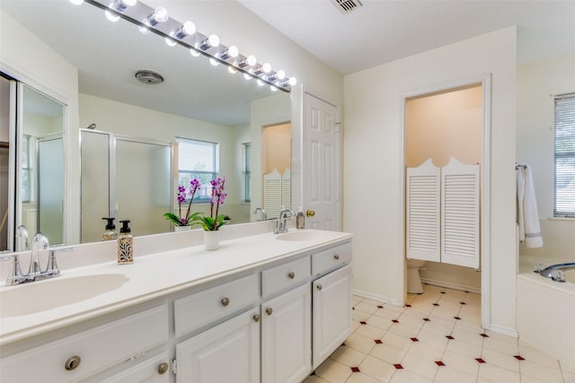 bathroom with vanity and separate shower and tub