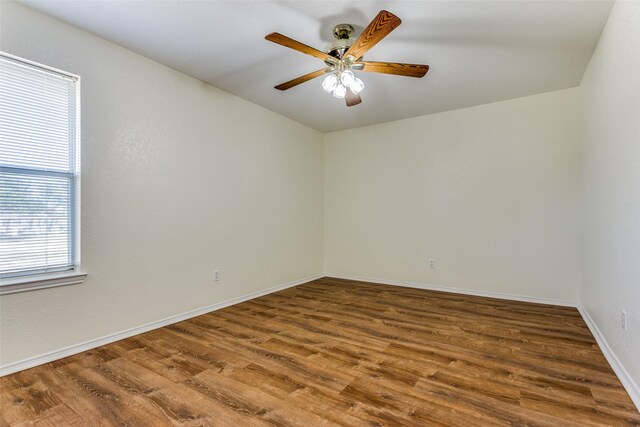 empty room featuring ceiling fan and hardwood / wood-style flooring