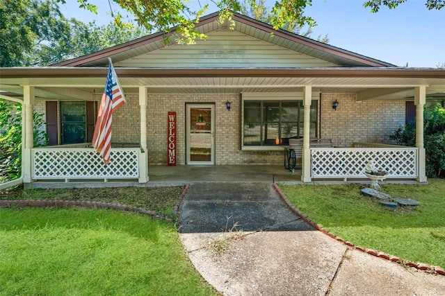 view of front of house with a front yard and a porch