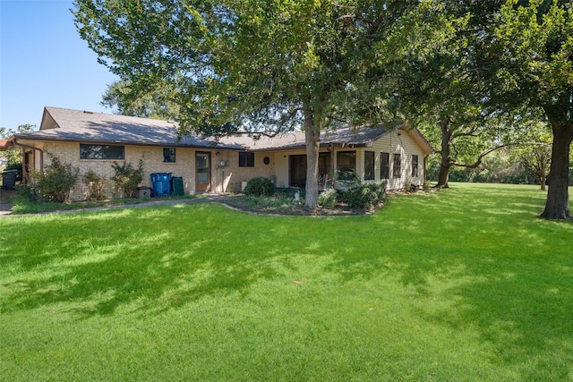 back of house featuring a yard