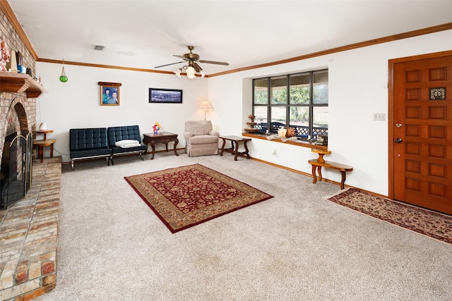 living room featuring crown molding, ceiling fan, a brick fireplace, and carpet