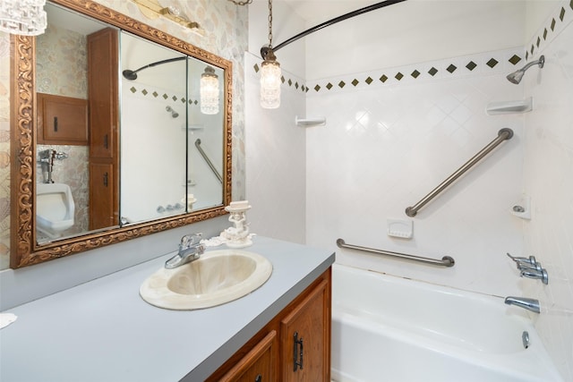 bathroom with tiled shower / bath and vanity