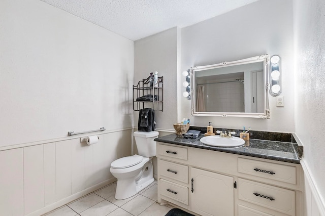 bathroom featuring a textured ceiling, a shower, tile patterned floors, vanity, and toilet