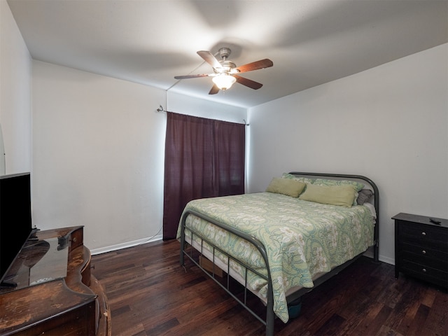 bedroom with ceiling fan and dark wood-type flooring