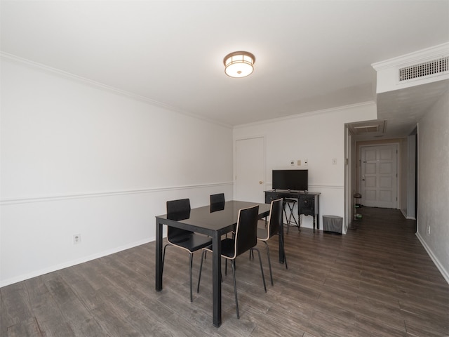 dining area featuring dark hardwood / wood-style floors and crown molding