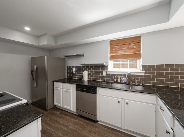 kitchen featuring dark wood-type flooring, sink, white cabinetry, decorative backsplash, and stainless steel appliances