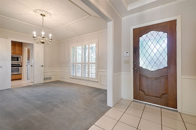 foyer entrance with crown molding, light carpet, a textured ceiling, and a chandelier