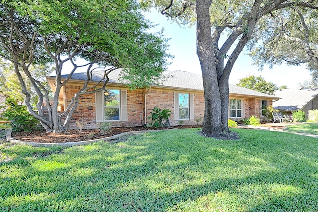 ranch-style home with a front yard