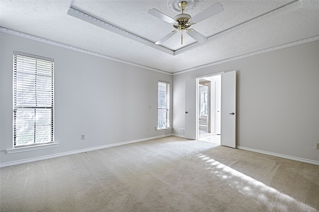 carpeted empty room with a textured ceiling, a healthy amount of sunlight, and ceiling fan