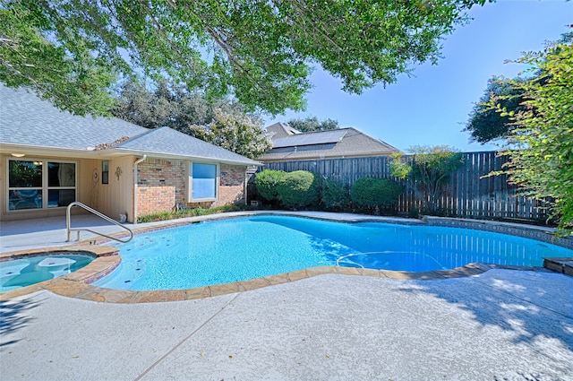 view of pool with a patio and an in ground hot tub