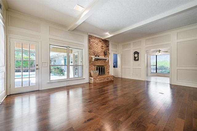 unfurnished living room featuring dark wood-type flooring and plenty of natural light