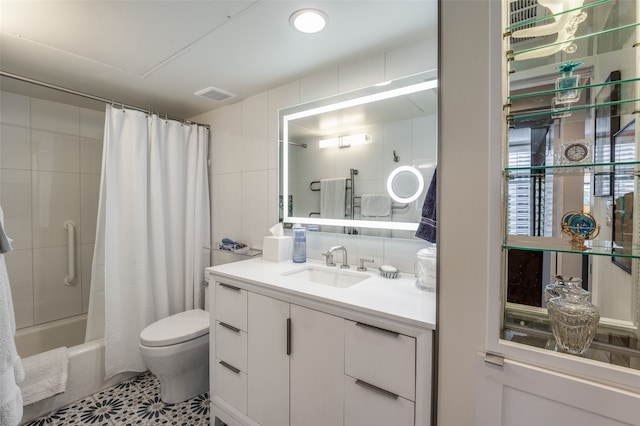 full bathroom featuring vanity, tile patterned floors, tile walls, toilet, and shower / tub combo with curtain