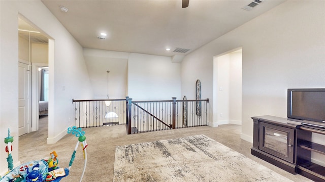 interior space with ceiling fan and light colored carpet