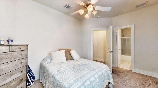 bedroom featuring ceiling fan, light colored carpet, and ensuite bathroom