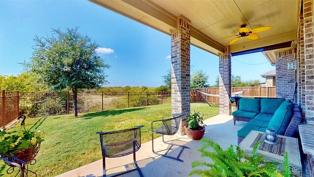 rear view of house featuring a patio, a lawn, outdoor lounge area, and ceiling fan