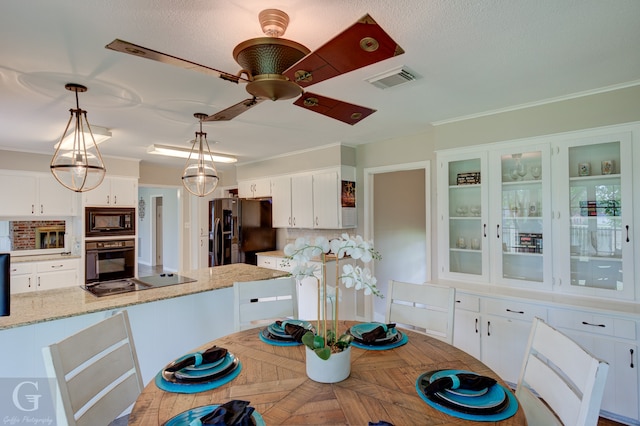 dining room with ceiling fan and crown molding