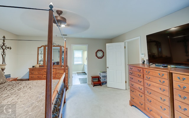 carpeted bedroom featuring ceiling fan and ensuite bathroom