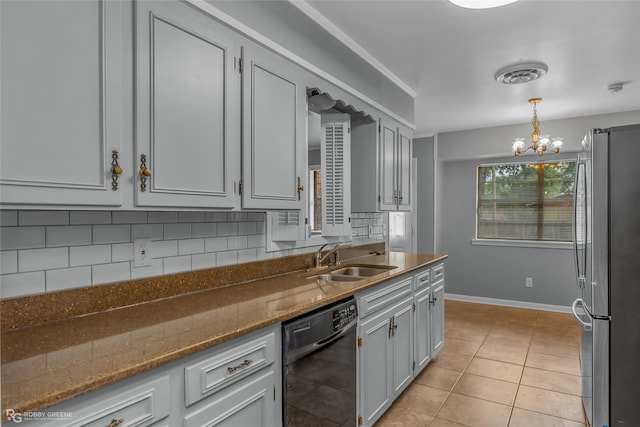 kitchen with light tile patterned flooring, sink, stainless steel refrigerator, a notable chandelier, and black dishwasher