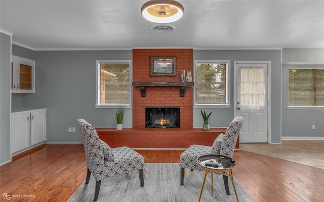 interior space featuring light hardwood / wood-style floors, a fireplace, and ornamental molding