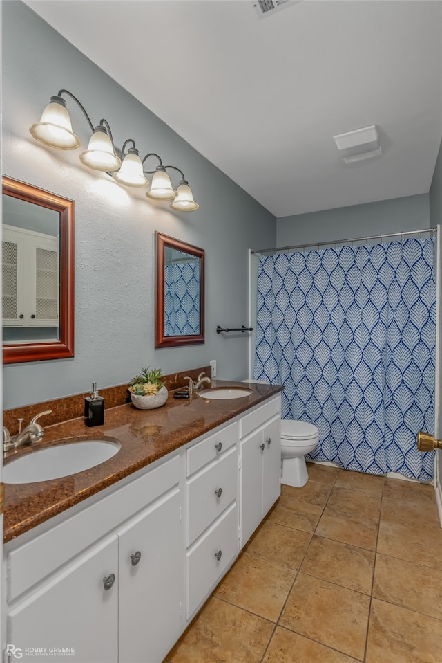 bathroom with vanity, tile patterned flooring, toilet, and curtained shower