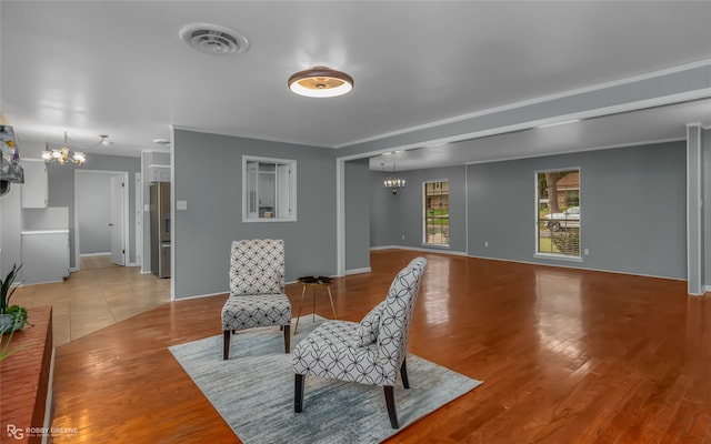 sitting room with light hardwood / wood-style flooring and a notable chandelier