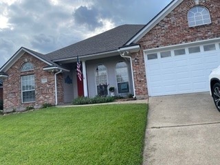 view of front of property with a garage and a front yard