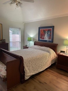 bedroom with wood-type flooring, ceiling fan, and ornamental molding