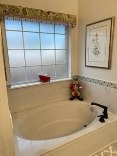 bathroom with tiled bath