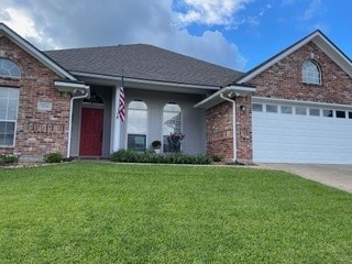 view of front facade with a garage and a front lawn