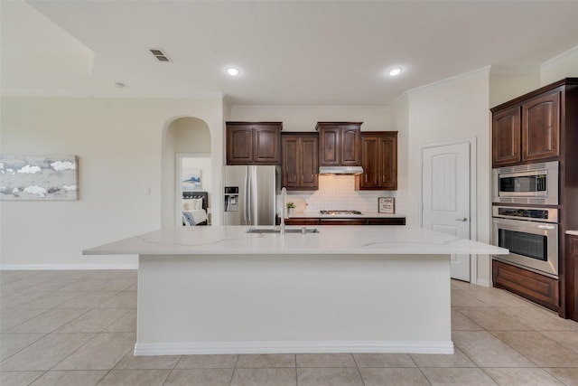 kitchen featuring appliances with stainless steel finishes, sink, a kitchen island with sink, and light tile patterned flooring