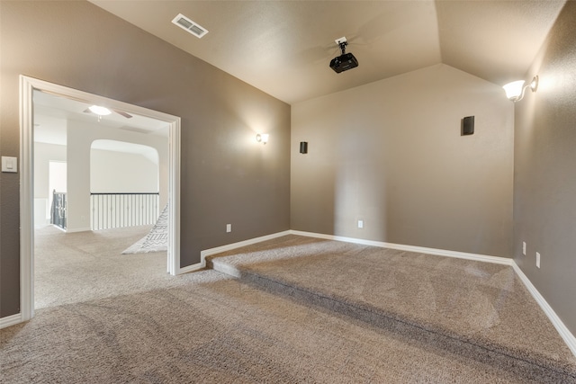 empty room featuring vaulted ceiling and carpet floors