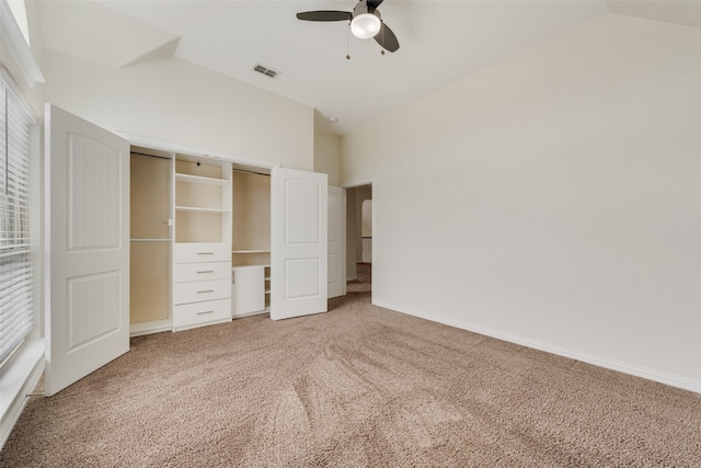 unfurnished bedroom featuring ceiling fan, a closet, lofted ceiling, and carpet flooring