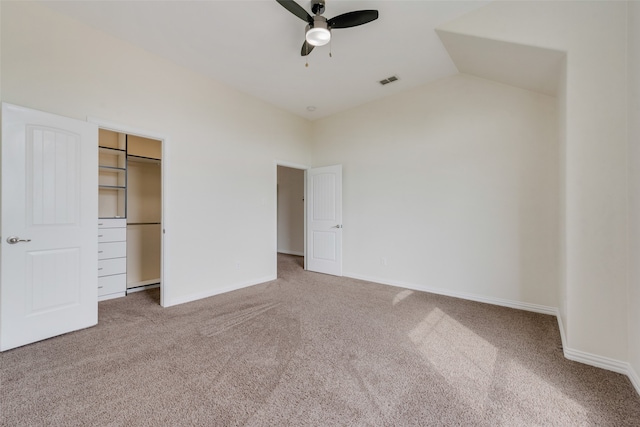 unfurnished bedroom with a closet, carpet, lofted ceiling, and ceiling fan