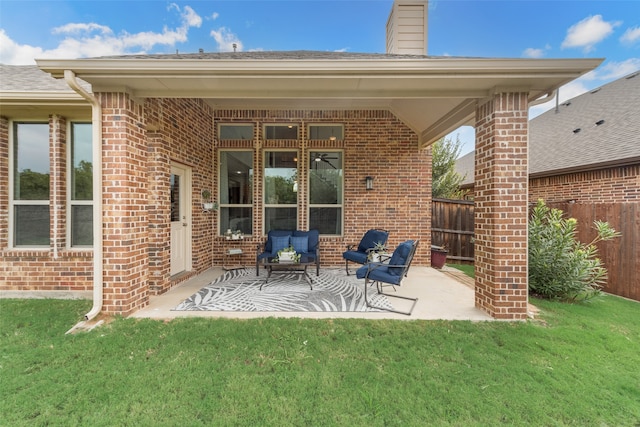 back of property with a yard and a patio