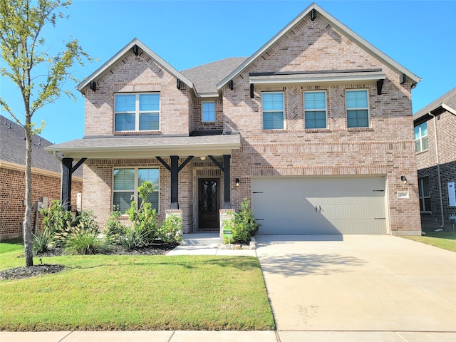 craftsman house featuring covered porch, a front yard, and a garage