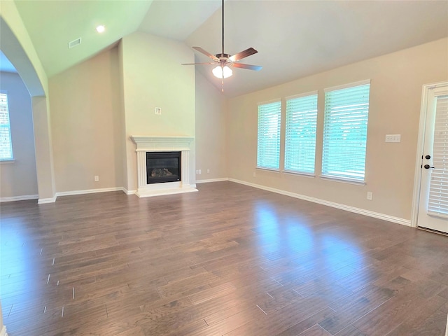 1516 Fairweather Way, Forney, TX 75126 - unfurnished living room with a ceiling fan, vaulted ceiling, healthy amount of natural light, dark wood-style flooring, and a glass covered fireplace