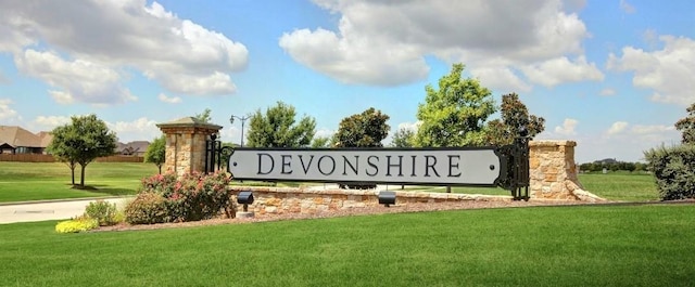 community / neighborhood sign with a lawn