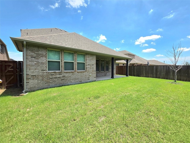 1516 Fairweather Way, Forney, TX 75126 - rear view of property featuring brick siding, a fenced backyard, a shingled roof, and a patio