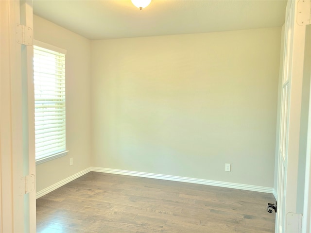 unfurnished room with plenty of natural light and hardwood / wood-style floors