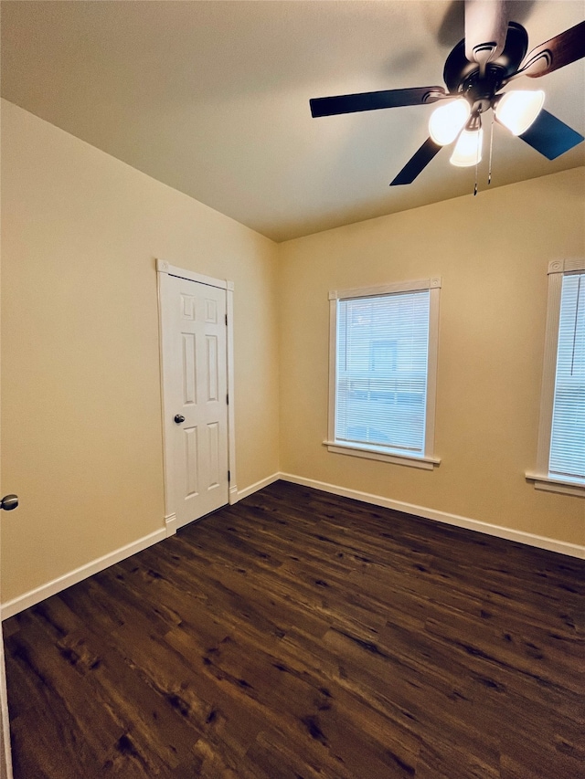 spare room featuring ceiling fan and dark hardwood / wood-style floors