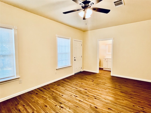 empty room featuring wood-type flooring and ceiling fan