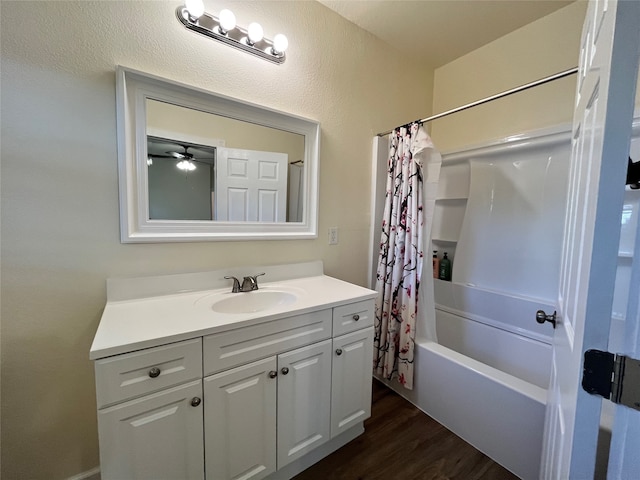 bathroom with ceiling fan, vanity, shower / tub combo, and hardwood / wood-style floors