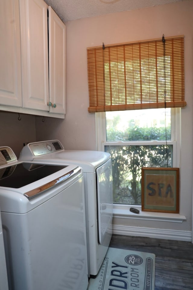 laundry area featuring a healthy amount of sunlight, cabinets, independent washer and dryer, and a textured ceiling