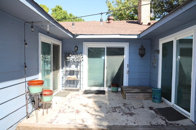 entrance to property featuring a patio area